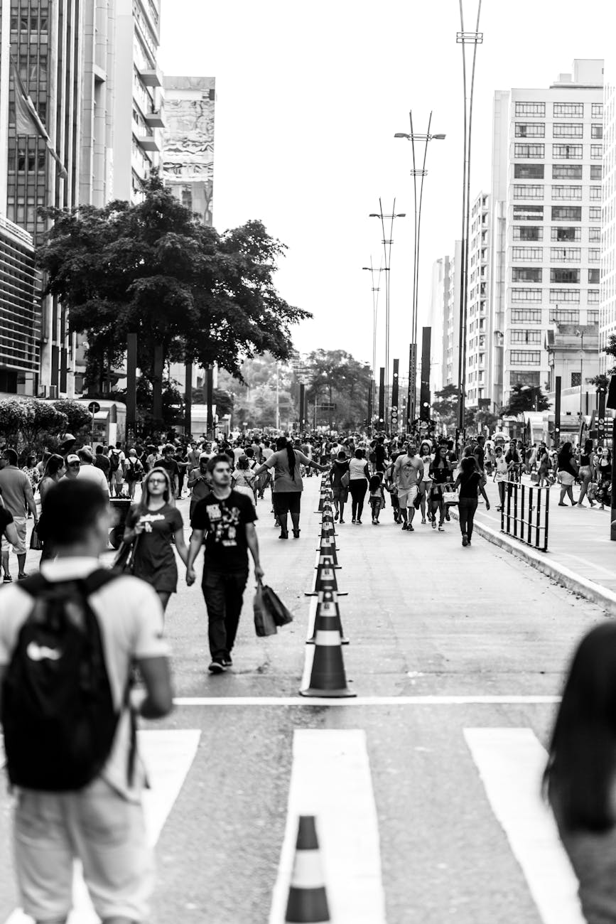 grayscale photo of people walking on the street