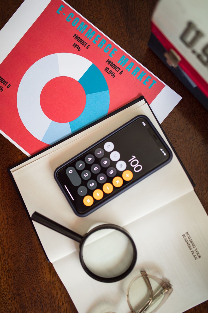 overhead shot of a cell phone on top of a book